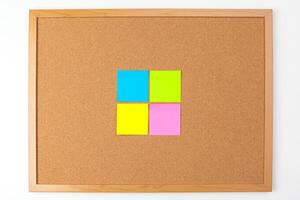 Cork board with several colorful blank notes with pins photo