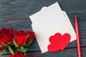 Red roses with message card. Valentines Day background photo