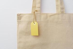 Eco bag for shopping with blank tag on white background photo