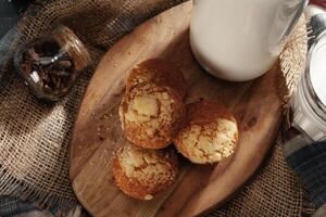 Glass of milk and cookies on table photo