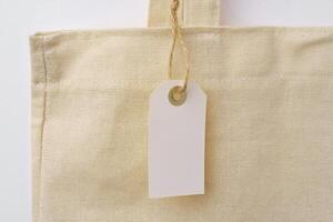 Eco bag for shopping with blank tag on white background photo