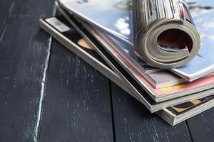 Close up stacking magazine place on table background photo
