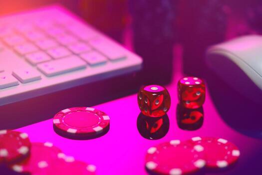 Red Dice on a Pink Surface With a Computer Keyboard and Mouse photo