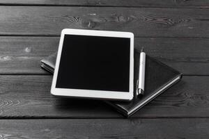 Empty digital tablet with notebook photo
