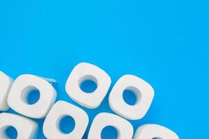 Rolls of toilet paper on color background, top view photo