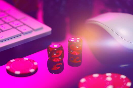 Red Dice on a Pink Surface With a Computer Keyboard and Mouse photo
