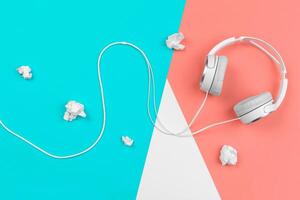 Headphones with cord on a bright color block background photo