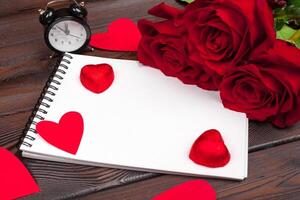 Valentine's day background. Empty blank notebook, gift box, flowers on a white background, top view. Free space for text photo