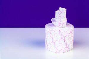 Roll of toilet paper or tissue on color background photo