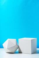 Two geometric shapes on display against a bright blue background in a modern setting photo