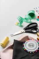Crafting essentials for sewing projects displayed on a table with fabric, threads, and tools photo