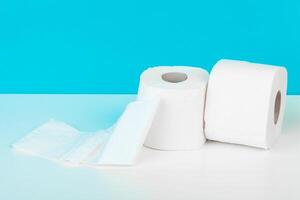 Roll of toilet paper or tissue on color background photo