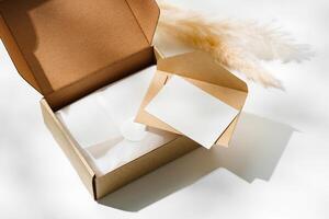 Delivery package with a blank envelope and decorative elements on a light background photo