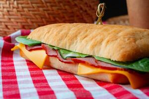 Ham sandwich with cheese and lettuce on table photo