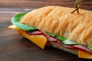 Ham sandwich with cheese and lettuce on table photo