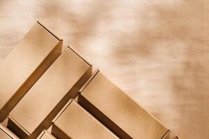 Brown cardboard boxes arranged on a neutral background in a warehouse setting during daylight hours photo