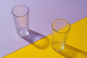 Empty transparent glass on a color background with copyspace. photo
