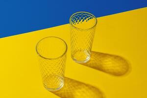 Empty transparent glass on a color background with copyspace. photo