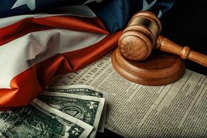 Wooden judge mallet with Dollars notes on the USA flag with Declaration of Independence photo
