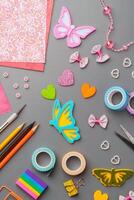 Crafting materials and tools arranged on a gray surface during a creative project photo