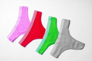 Set of cotton string women's panties on white background photo