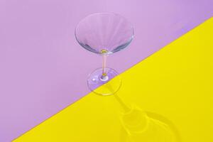 Empty transparent glass on a color background with copyspace. photo