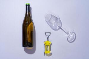 Wine bottle and glass on gray background flat lay photo