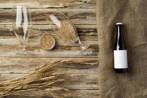 A bottle of beer and grain. Top view. Free space for text. photo