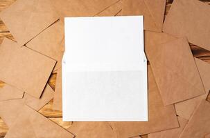 Stack of envelopes on working desk top view. Business mail photo