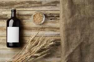A bottle of beer and grain. Top view. Free space for text. photo