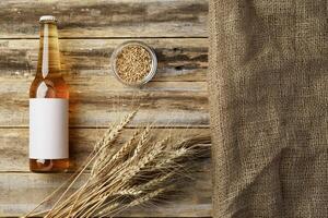 A bottle of beer and grain. Top view. Free space for text. photo