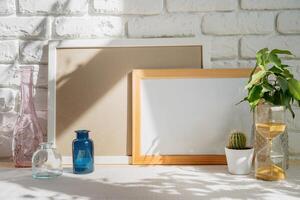 Mockup with a frame and dry flowers in a vase on a white table photo