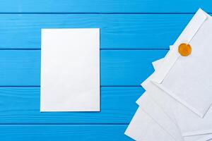 Stack of envelopes on working desk top view. Business mail photo