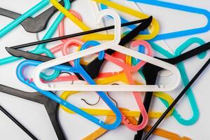 a pile clothes hangers on isolated white background photo