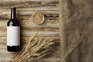 A bottle of beer and grain. Top view. Free space for text. photo