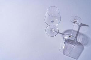 Two empty wine glass on gray background top view photo
