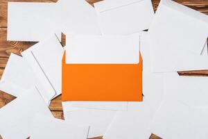 Stack of envelopes on working desk top view. Business mail photo