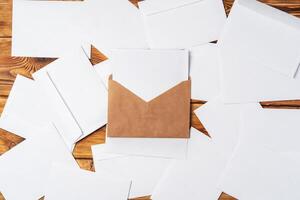 Stack of envelopes on working desk top view. Business mail photo