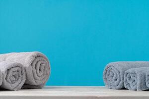 Stack of rolled towels on a wooden table photo
