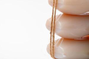 Soap bars tied with twine on white background photo