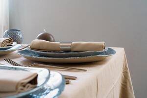 Table setting with stylish dishware on beige tablecloth photo
