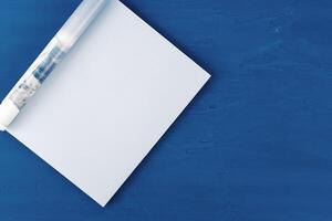 Top view of open magazine page with copy space on classic blue background photo