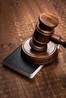 Image of wooden judge hammer on notepad photo