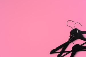Flat lay composition with empty hangers on pink background photo