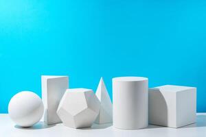 Various geometric shapes arranged on a surface against a bright blue background photo
