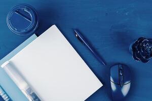Top view of open magazine page with copy space on classic blue background photo