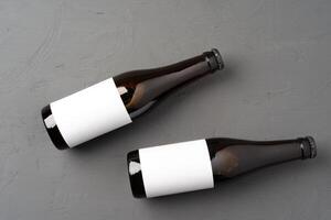 Beer bottle, on gray stone background, top view, with copy space for text photo