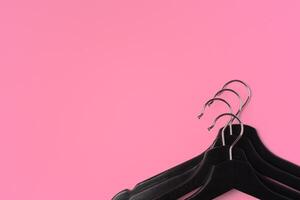 Flat lay composition with empty hangers on pink background photo