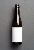 Beer bottle, on gray stone background, top view, with copy space for text photo