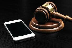 Cyber crime concept. Judge gavel and tablet computer on table photo